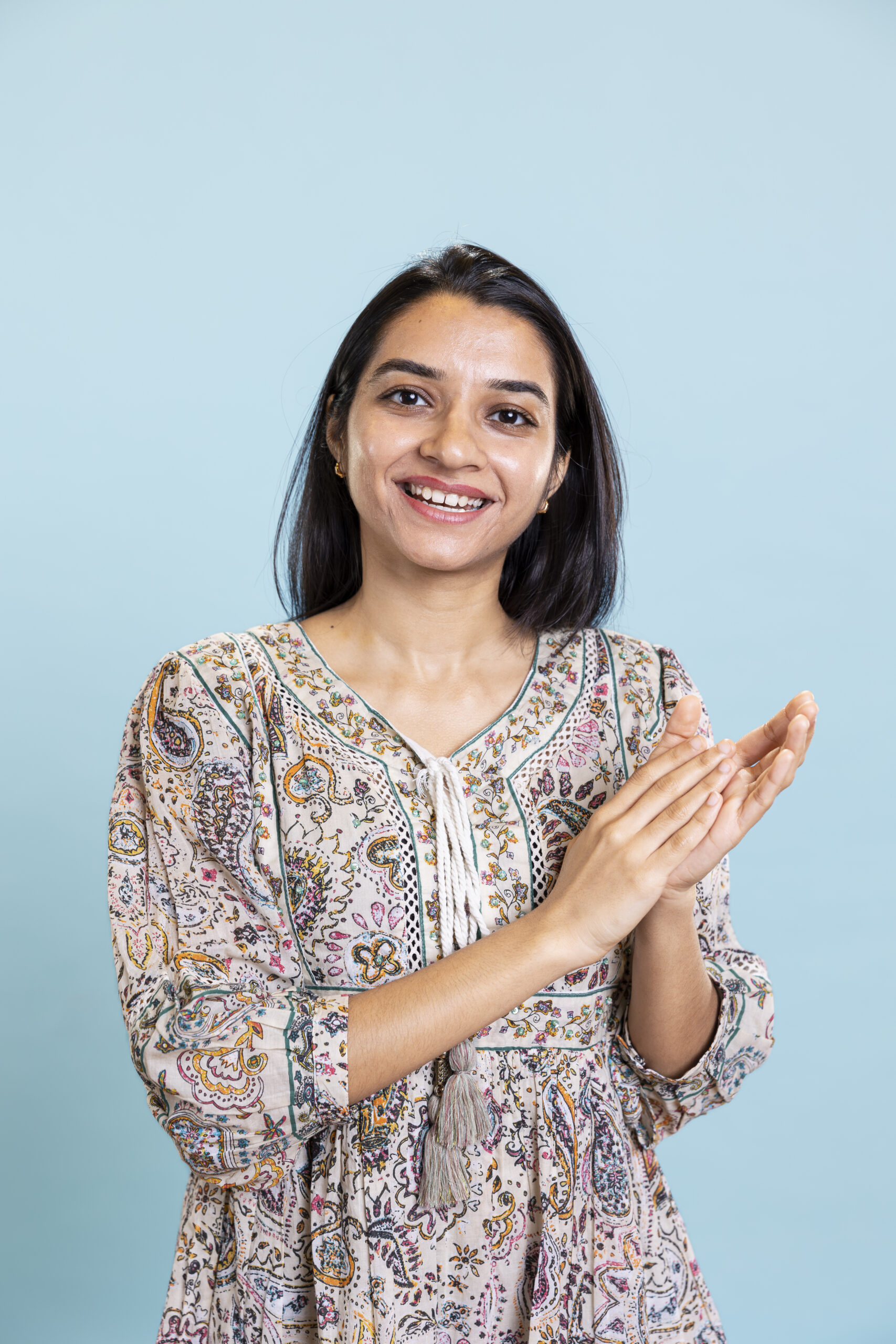 indian satisfied woman clapping hands and feeling proud of a milestone